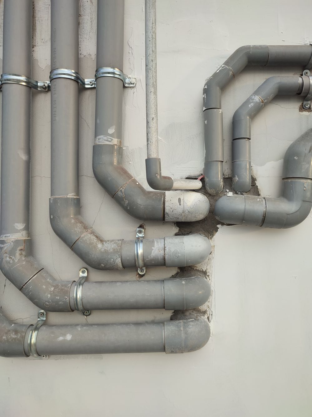 Interconnected gray metal pipes outdoors