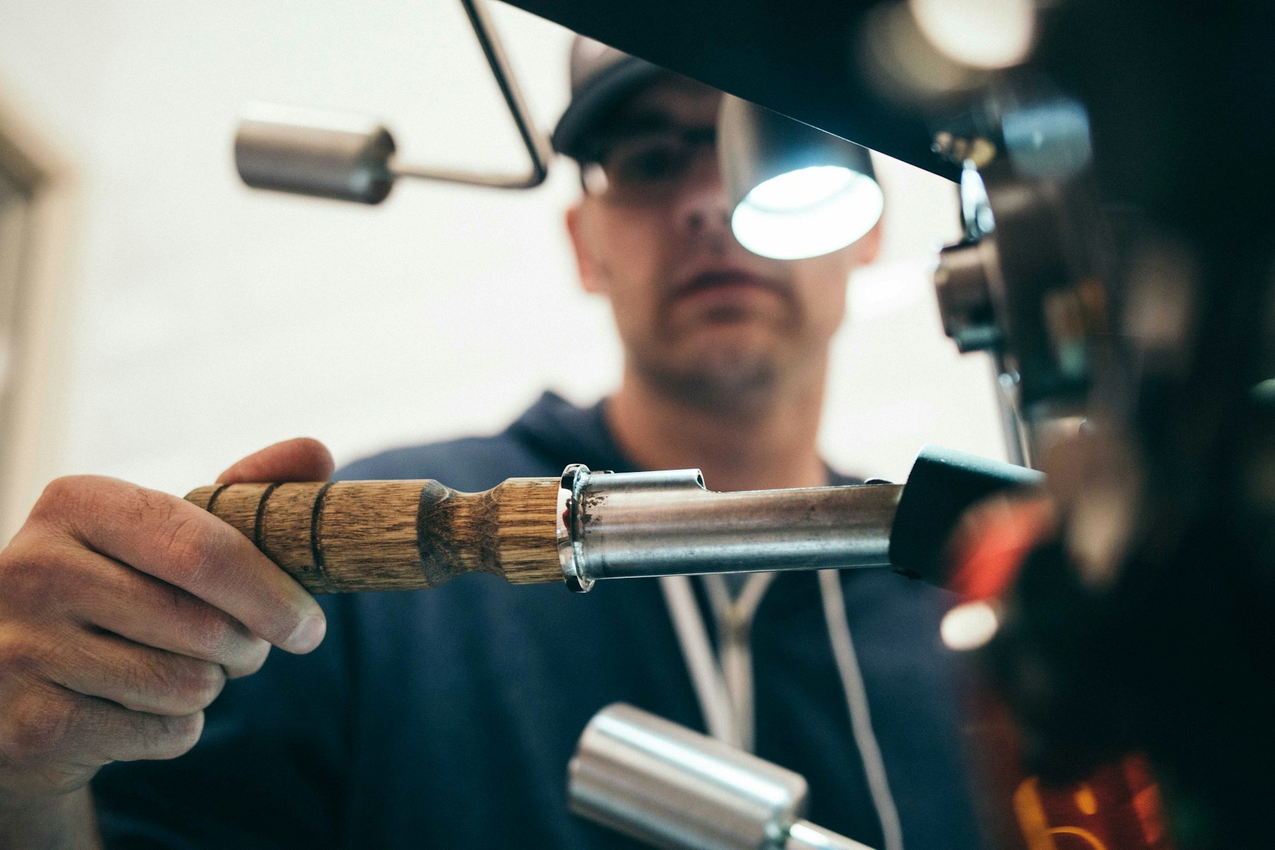 Plumber wearing a headlamp working on a pipe with a hand tool
