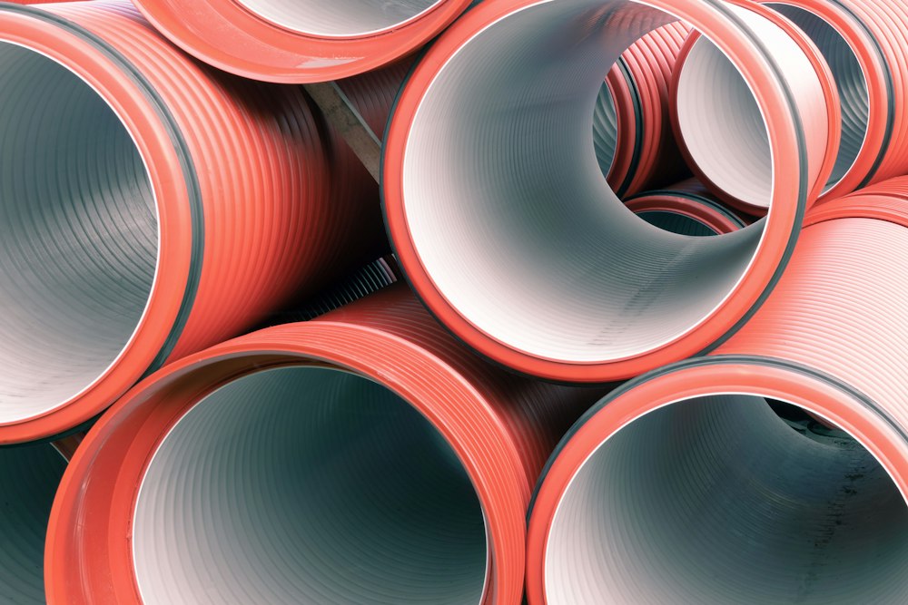 Stacked PVC drainage pipes ready for installation