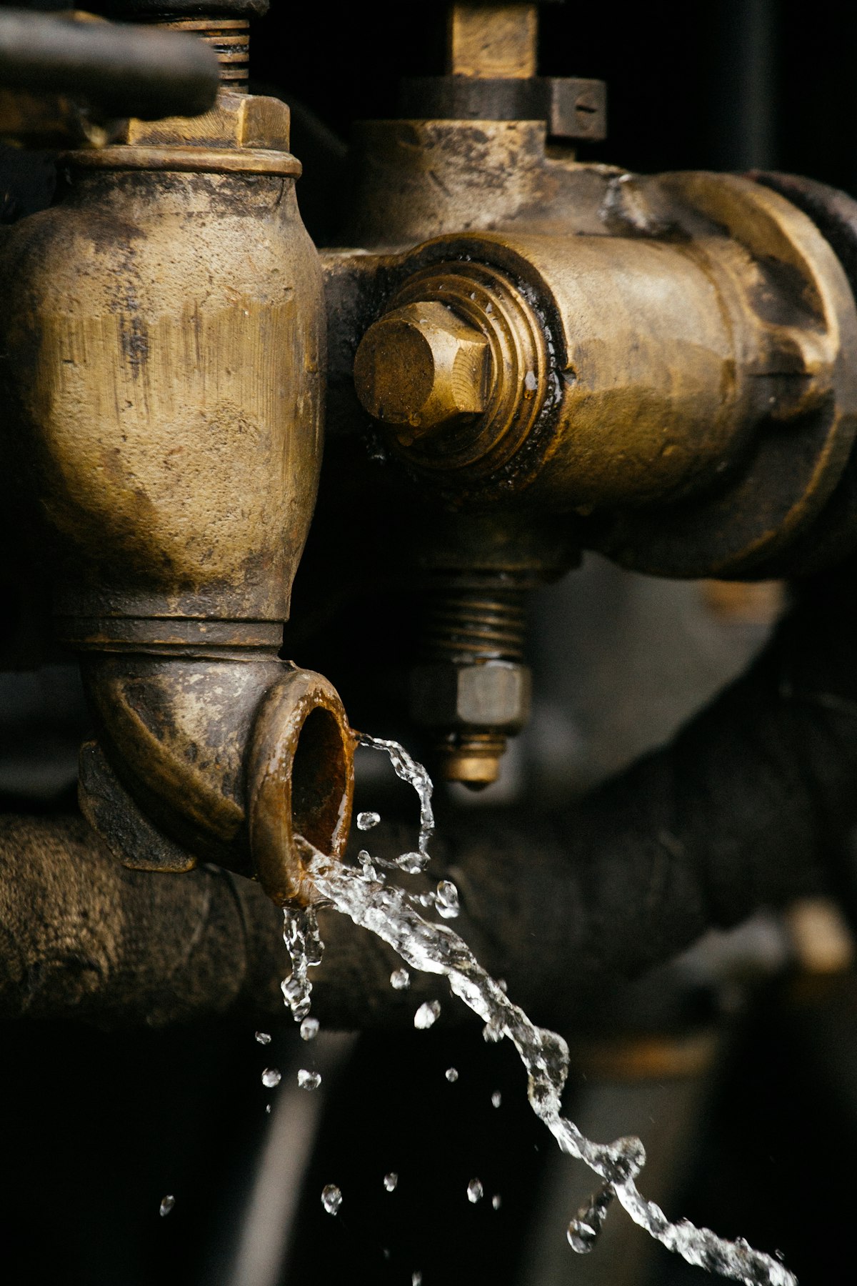 Water drop leaking from a brass pipe joint