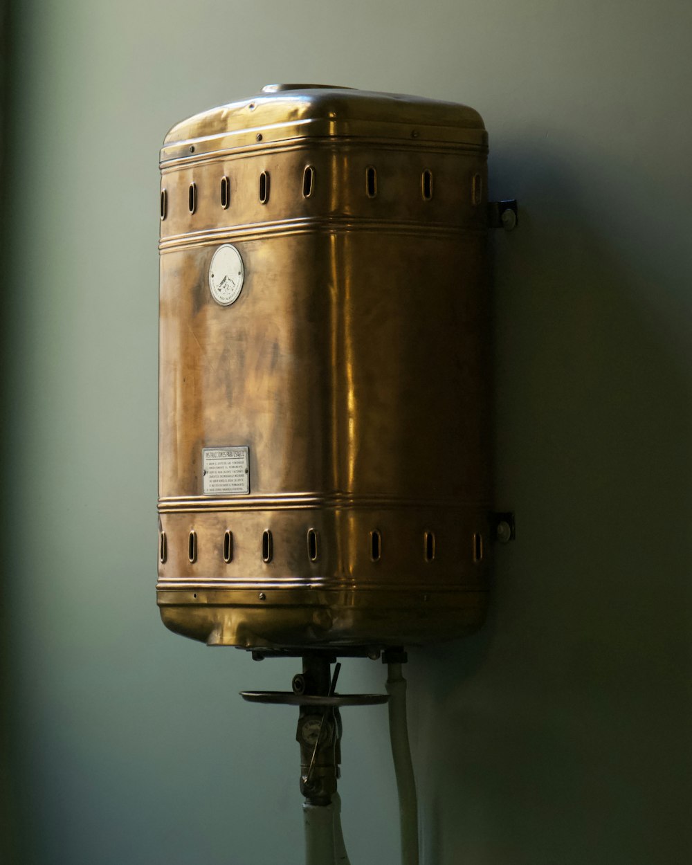 Water heater tank connected to supply pipes