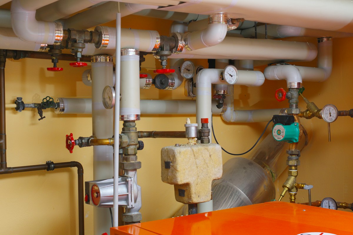 Neatly installed water pipe manifold with valves and pressure gauges