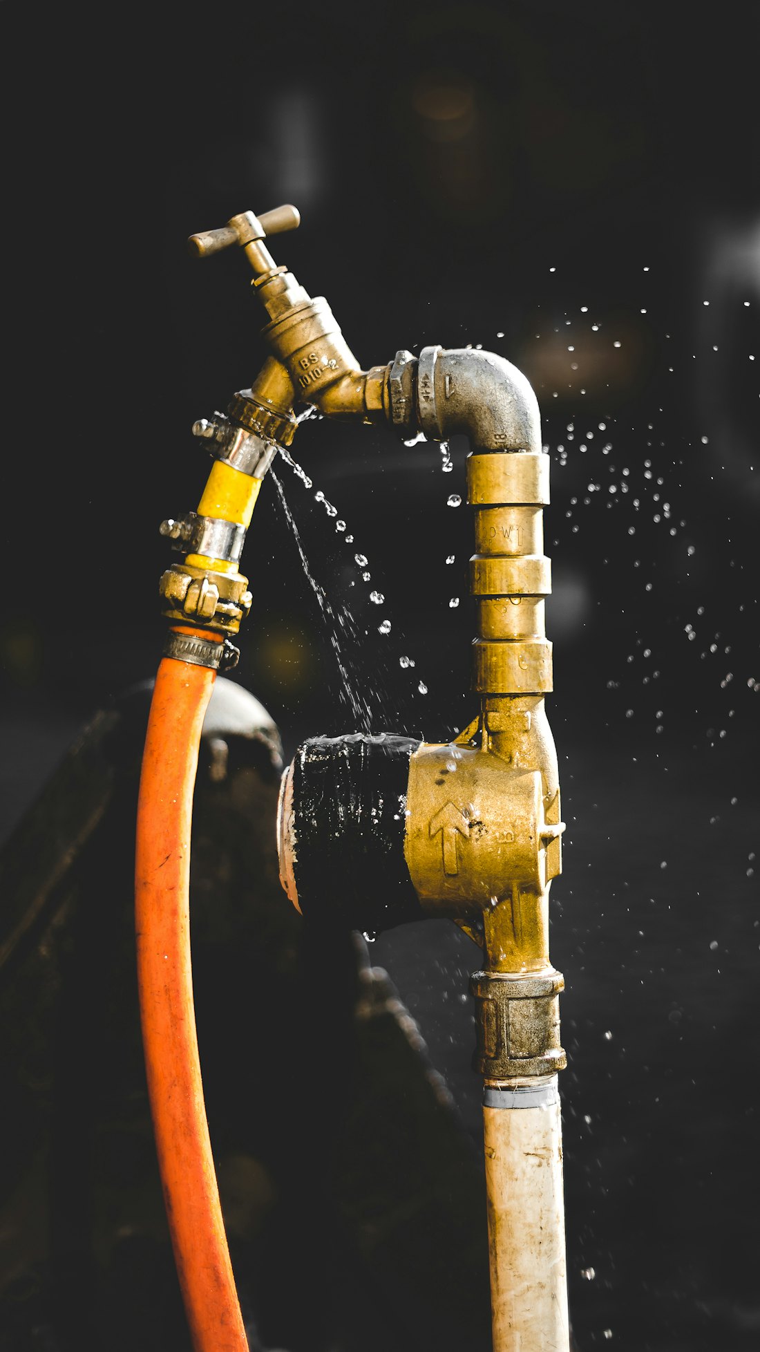 Water spraying from a leaking brass pipe joint